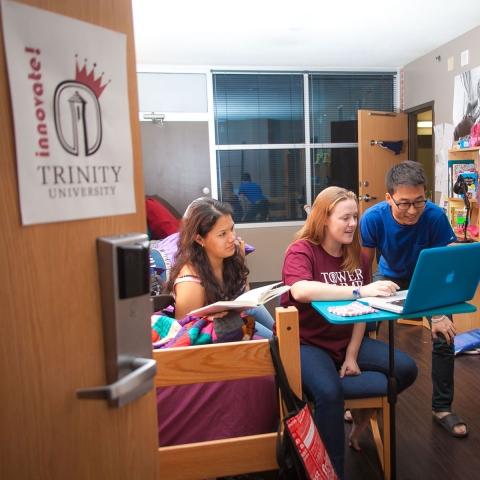 three students study together in an entrepreneurship hall dorm room