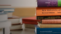 Books from several disciplines stacked in a pile.