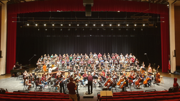 a wide shot of the choir and orchestra on stage at Trinity's 2023 Choral Union Concert