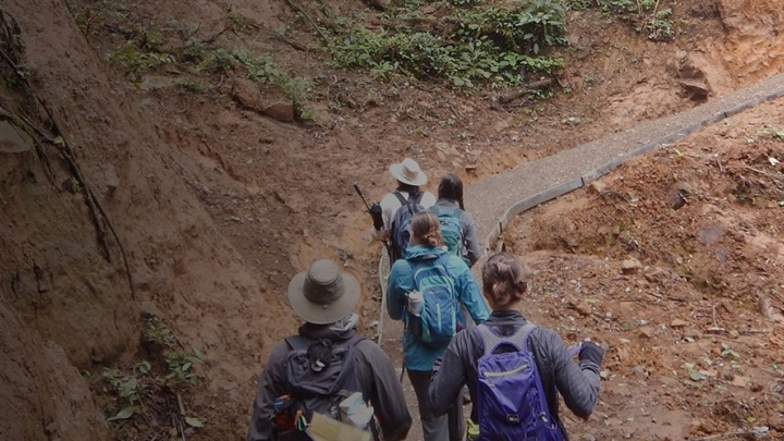 Students and faculty hiking across a terrain on a study abroad trip