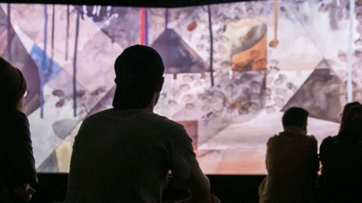 Students review a digital art exhibition