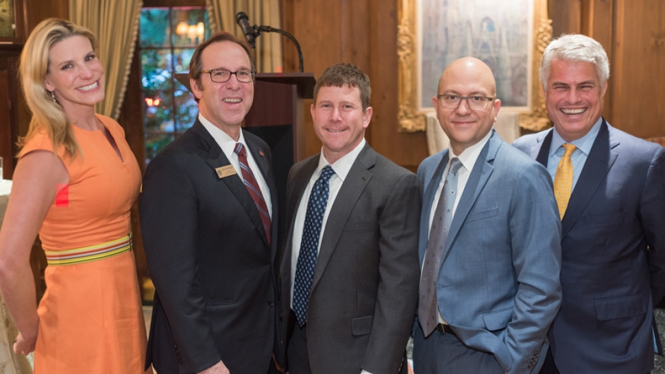 Businesspeople pose with president Danny Anderson