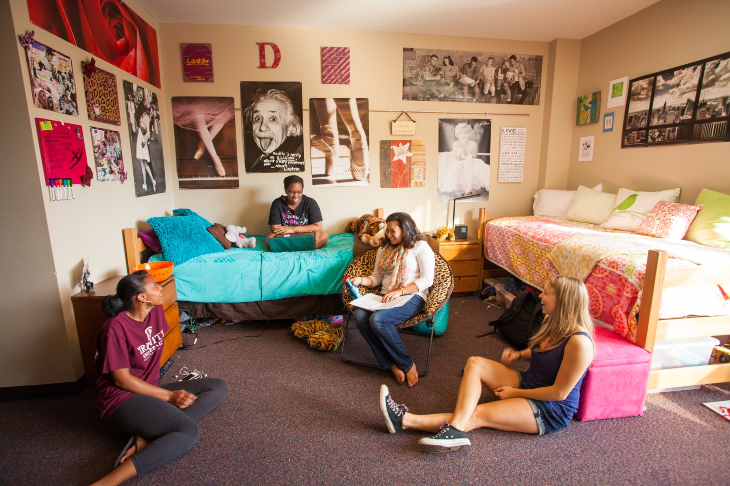 four women sit inside a Prassel Hall dorm room
