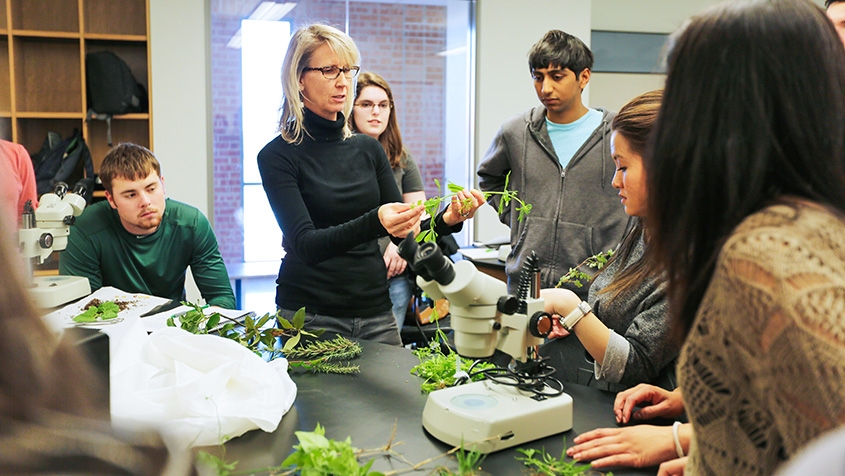 Kelly Lyons with plants teaching students