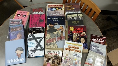 Group of graphic Holocaust novels on a table