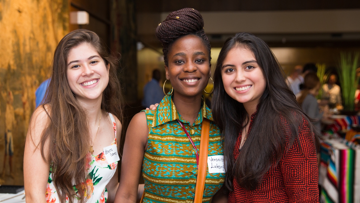  Three international women students pose at the international dinner reception.