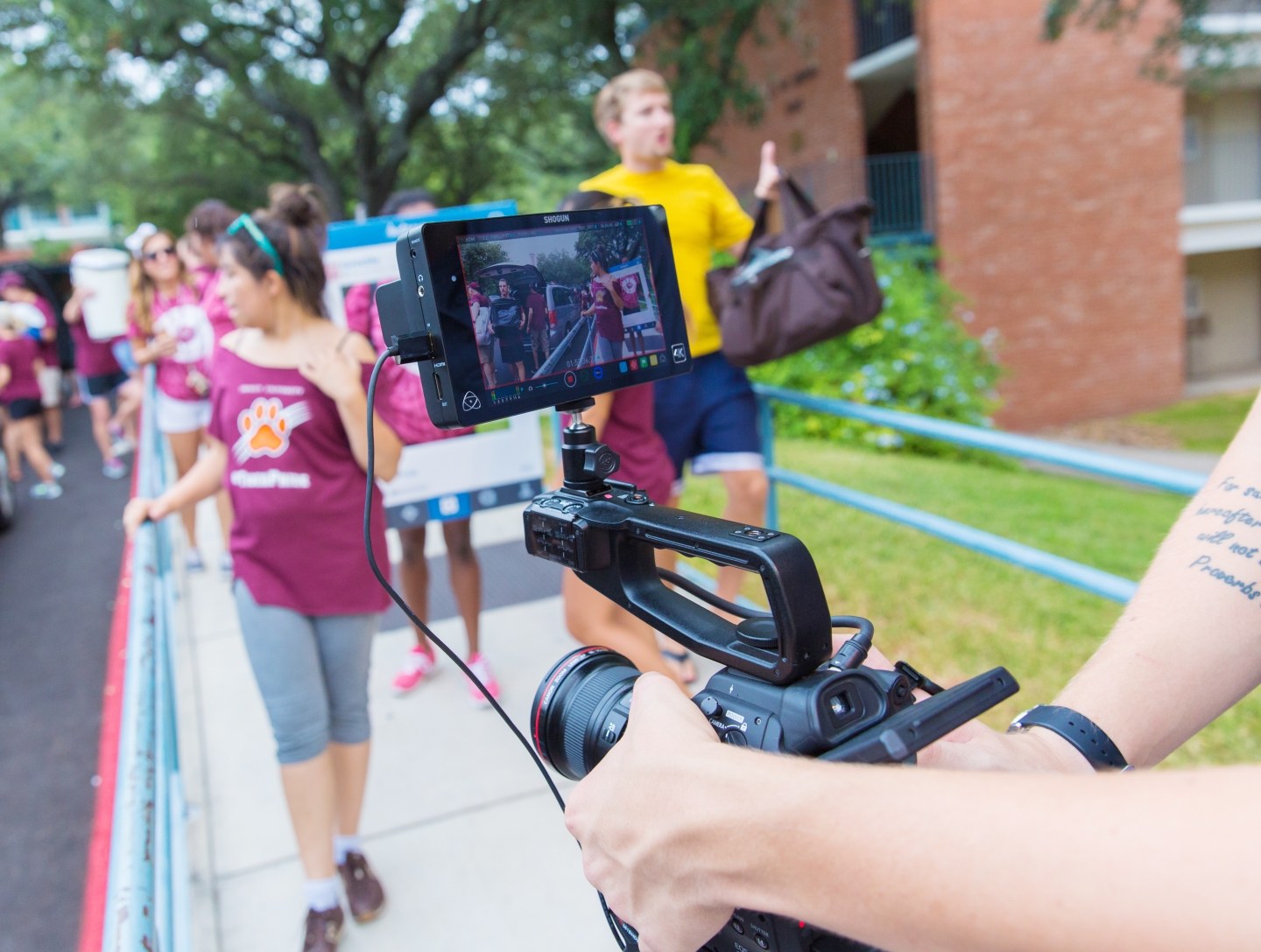 a video camera is in focus filming the action in the first-year quad during Move-In Day