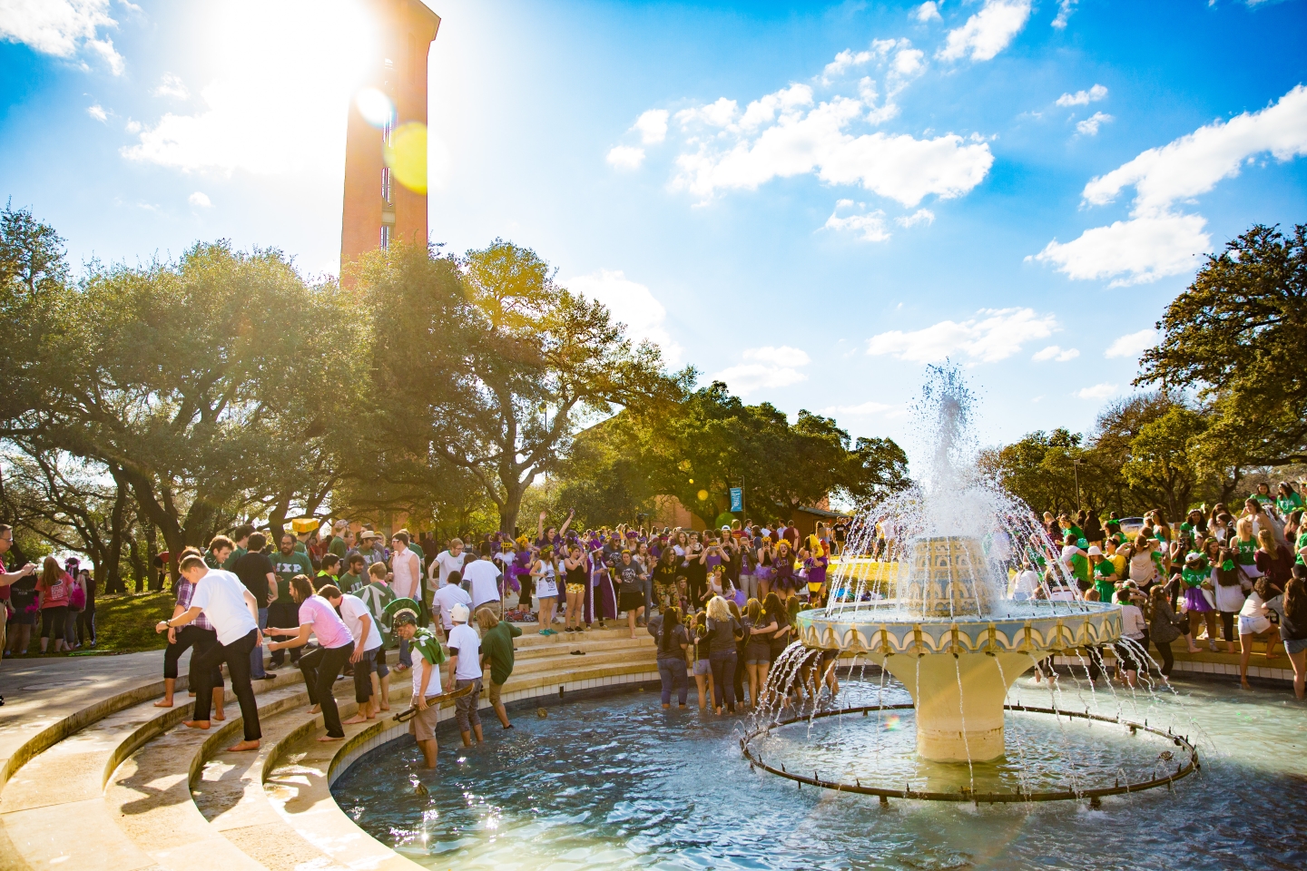 Dozens of Fraternity and Sorority members gather in Miller Fountain during a sunny Bid Day