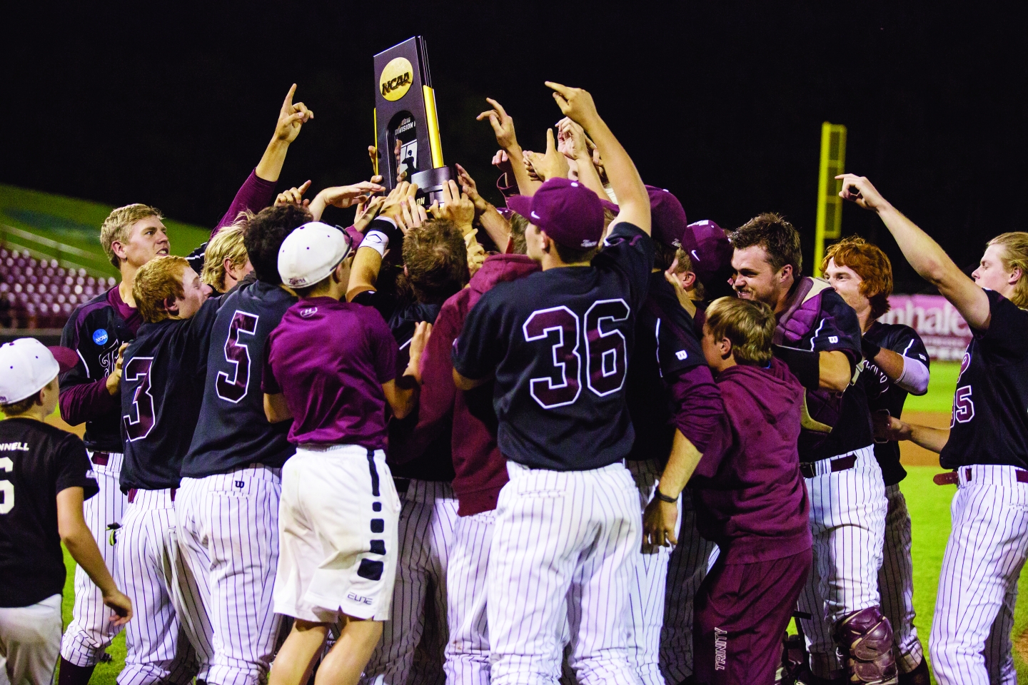 Trinity Baseball celebrates with the DIII National Championship trophy.