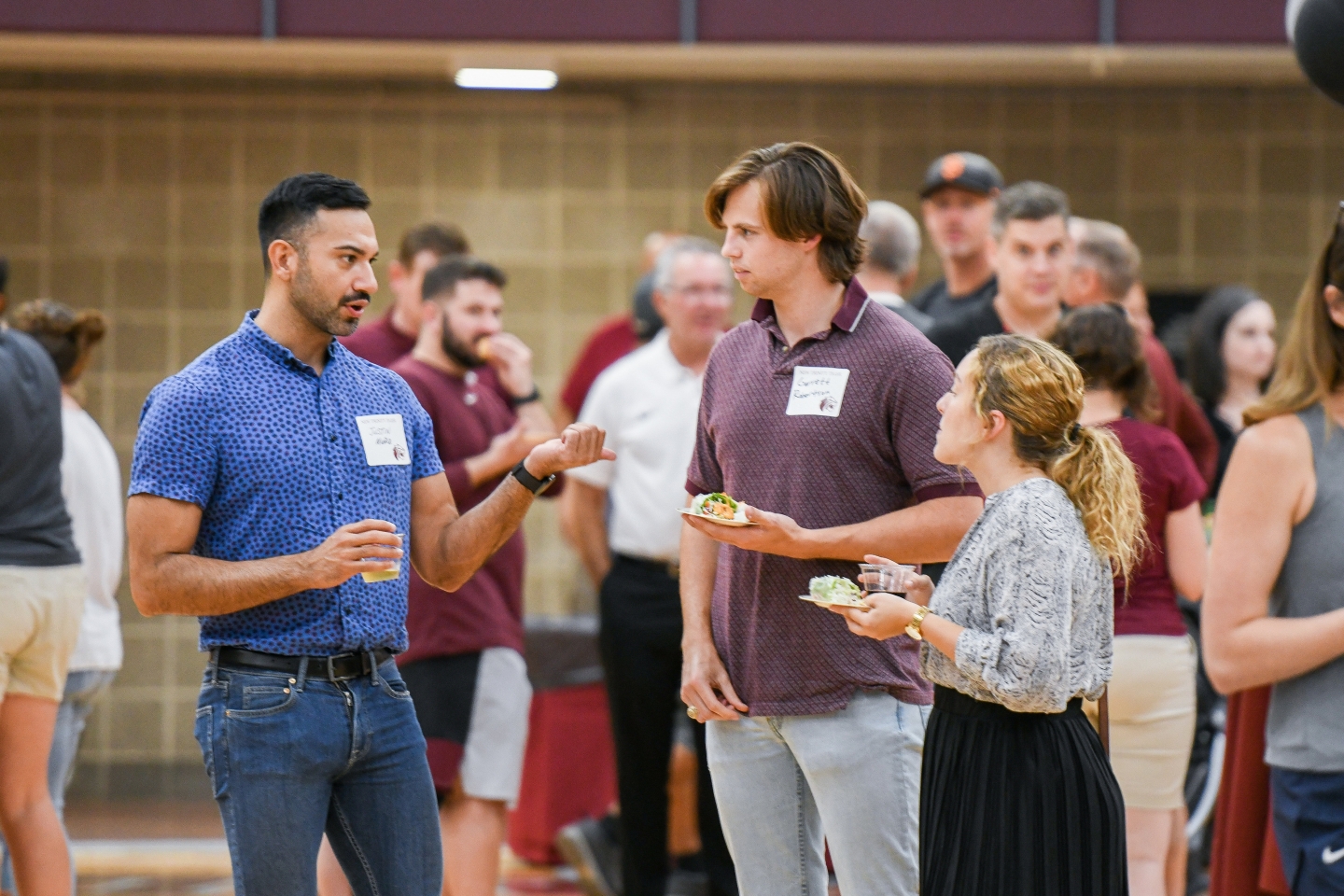 Staff from the Strategic Communications and Marketing office mingling at the faculty and staff welcome back party