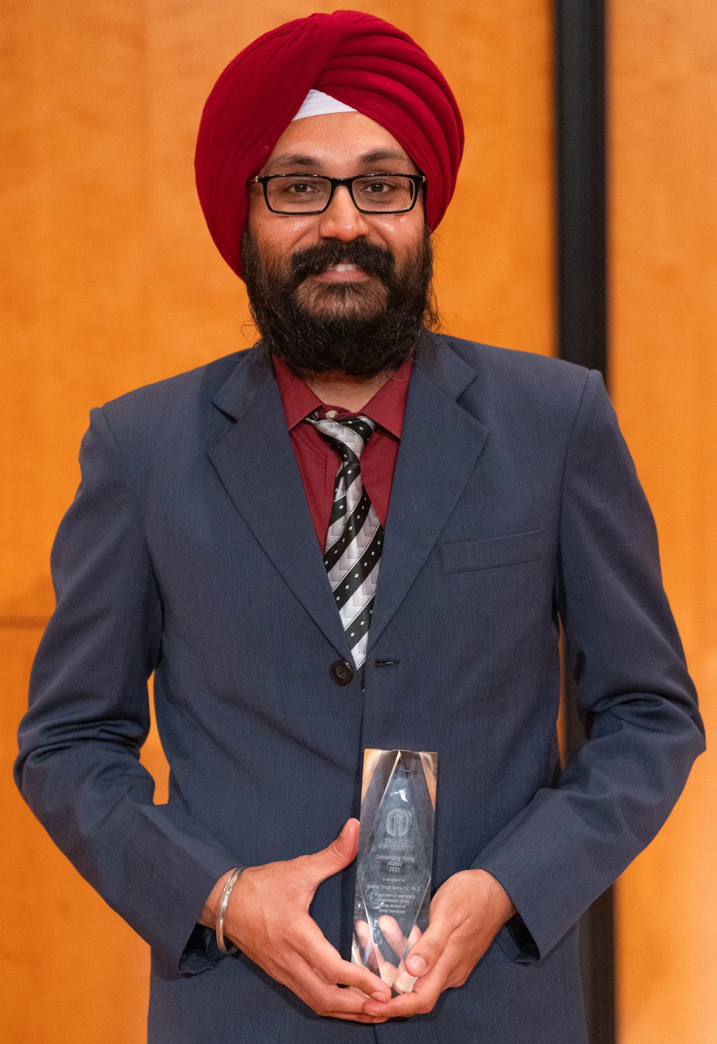 Photo of Jaskirat Singh Batra '12, Ph.D. holding an Alumni Award
