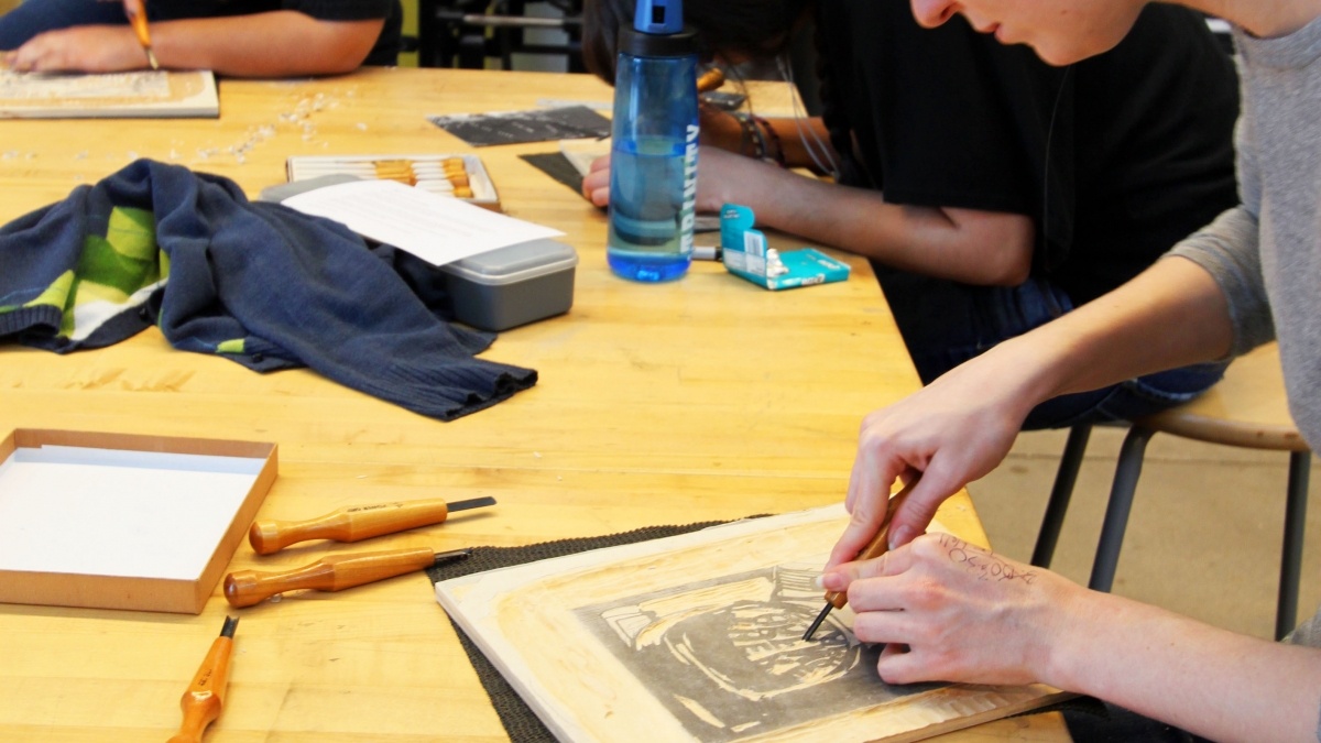 Students working at a table drawing