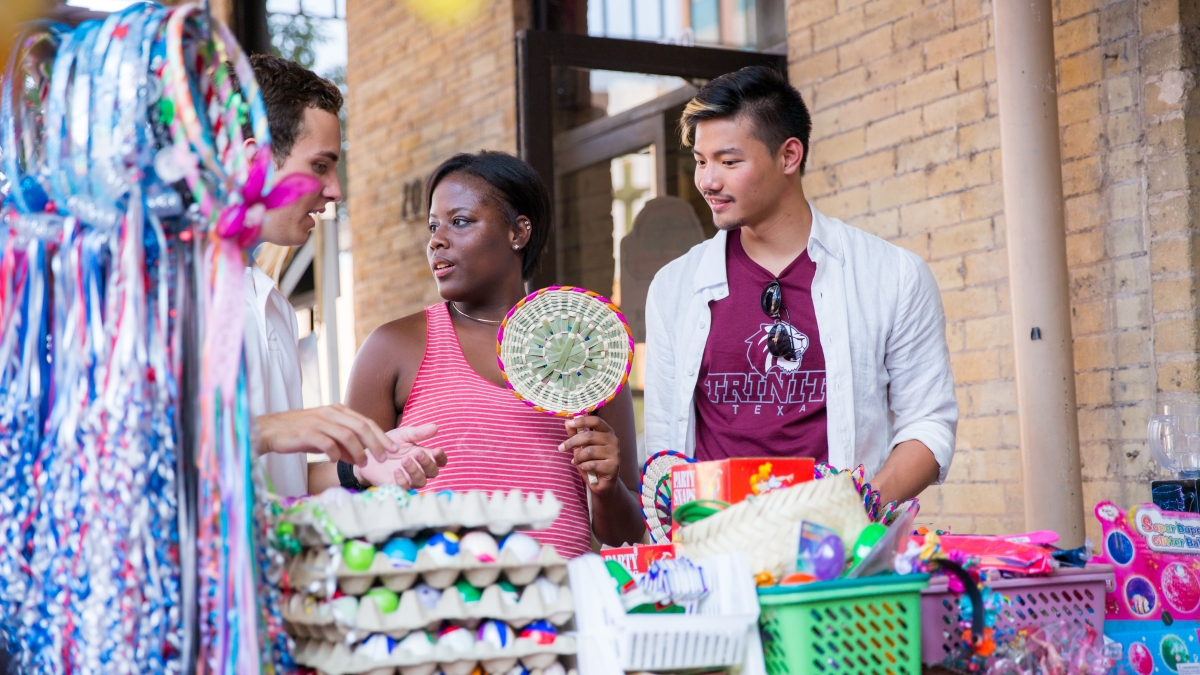 three students shop for trinkets in historic market square