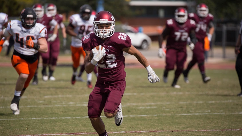 Chris Stewart running on football field