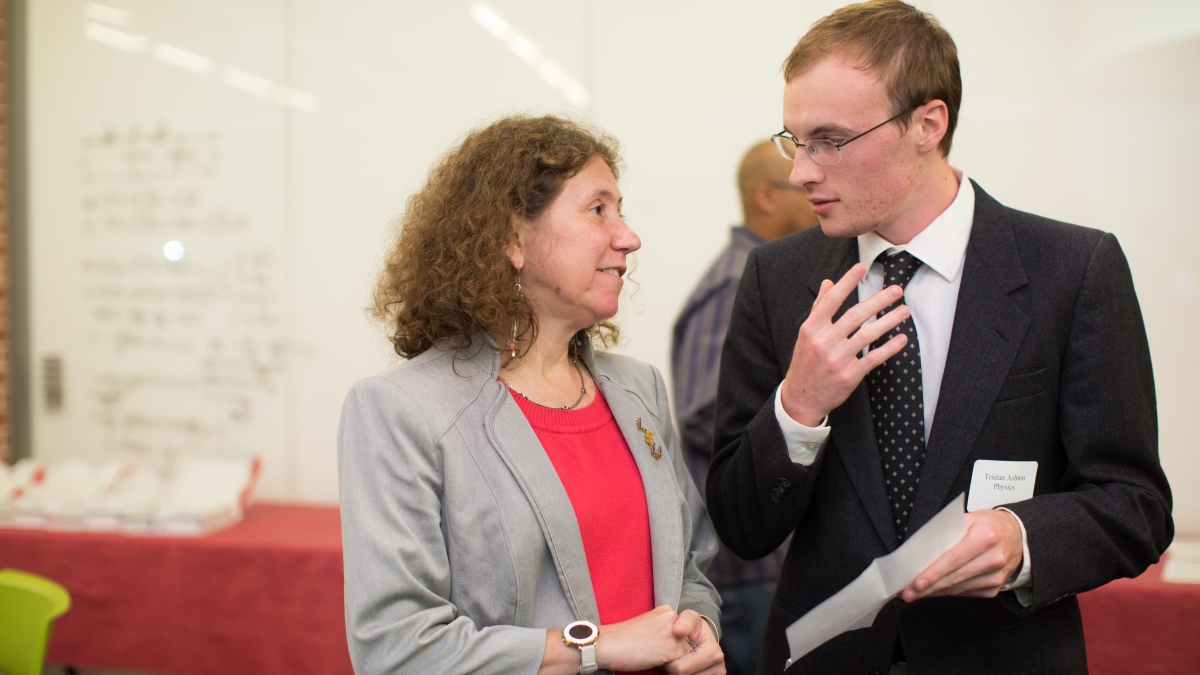 Gabriela Gonzalez speaks with a student before a lecture in CSI