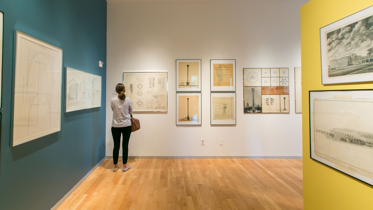 a woman pauses in front of an oneil ford drawing in the trinity art gallery