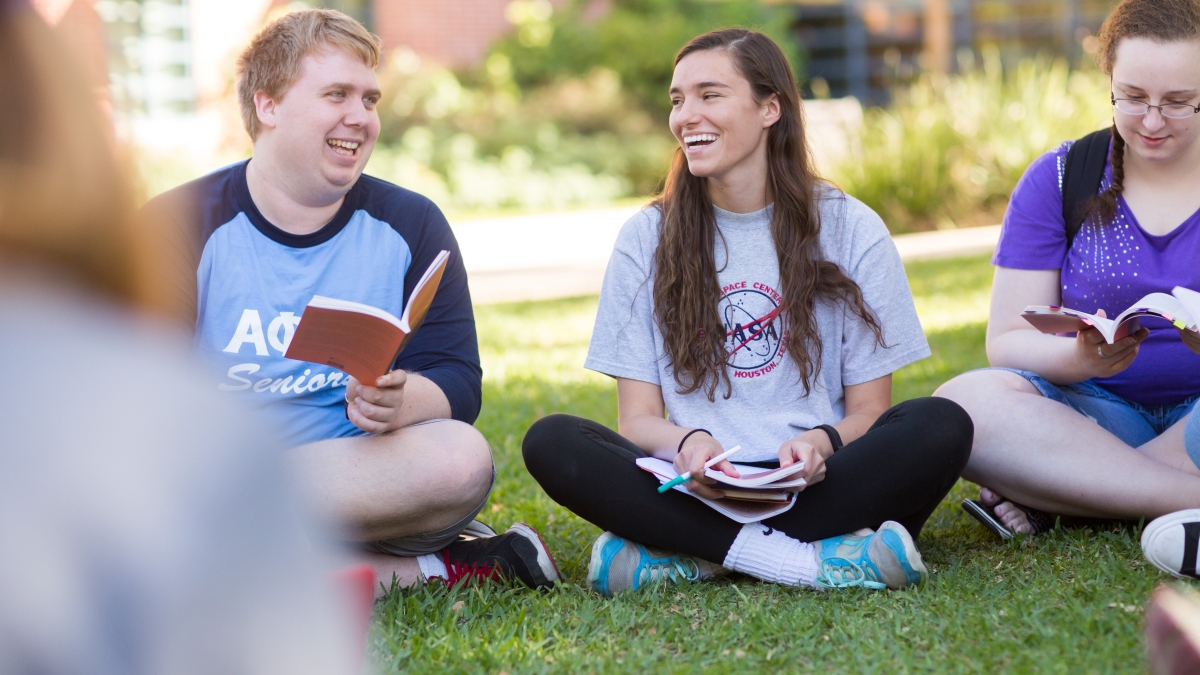 Students read together on the lawn of Northrup Hall.