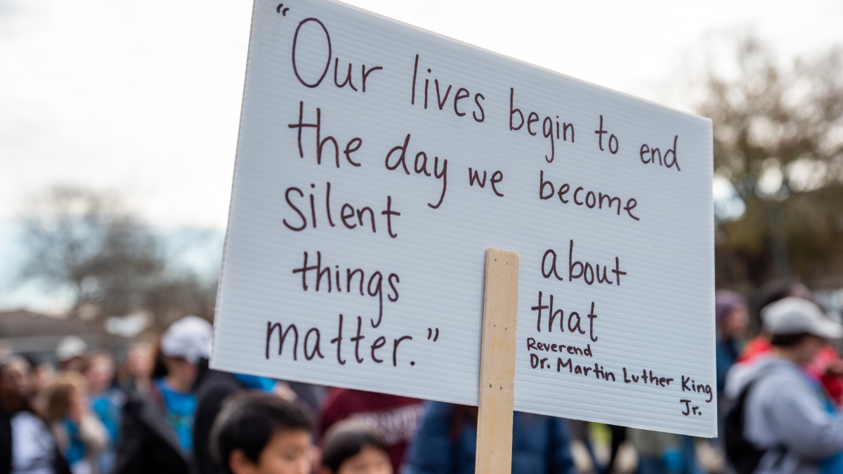 Sign with Martin Luther King Jr. quote being held up