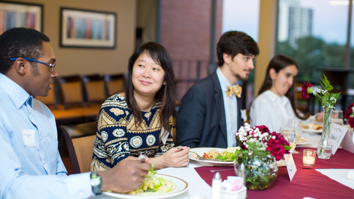 Hoa Nguyen speaks with a student over dinner in Skyline Dining Room
