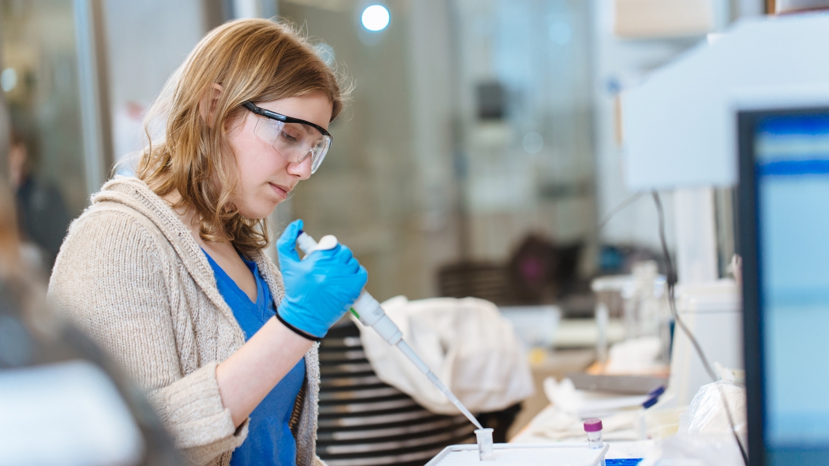 Woman uses an advanced pipette for an experiment