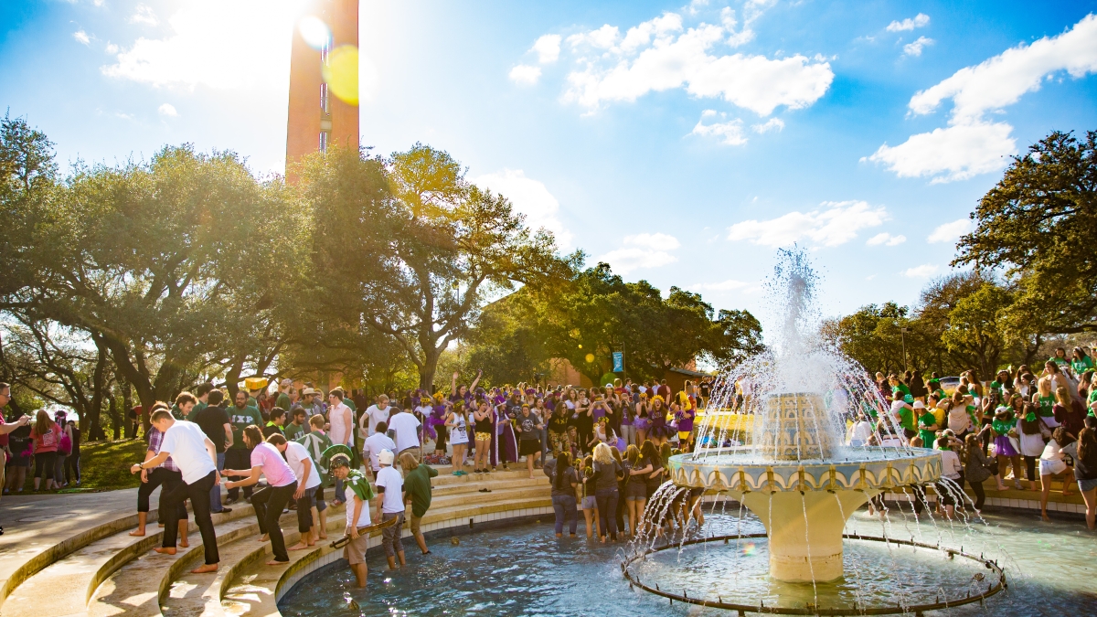 Dozens of Fraternity and Sorority members gather in Miller Fountain during a sunny Bid Day