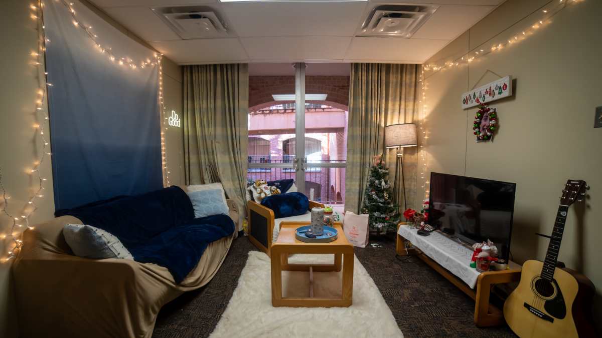Lightner Hall dorm room living area decorated with guitar in the room and a christmas tree